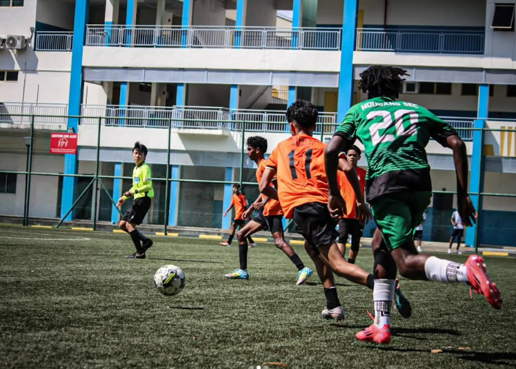 CCKSS football team in action during a competitive school football match.